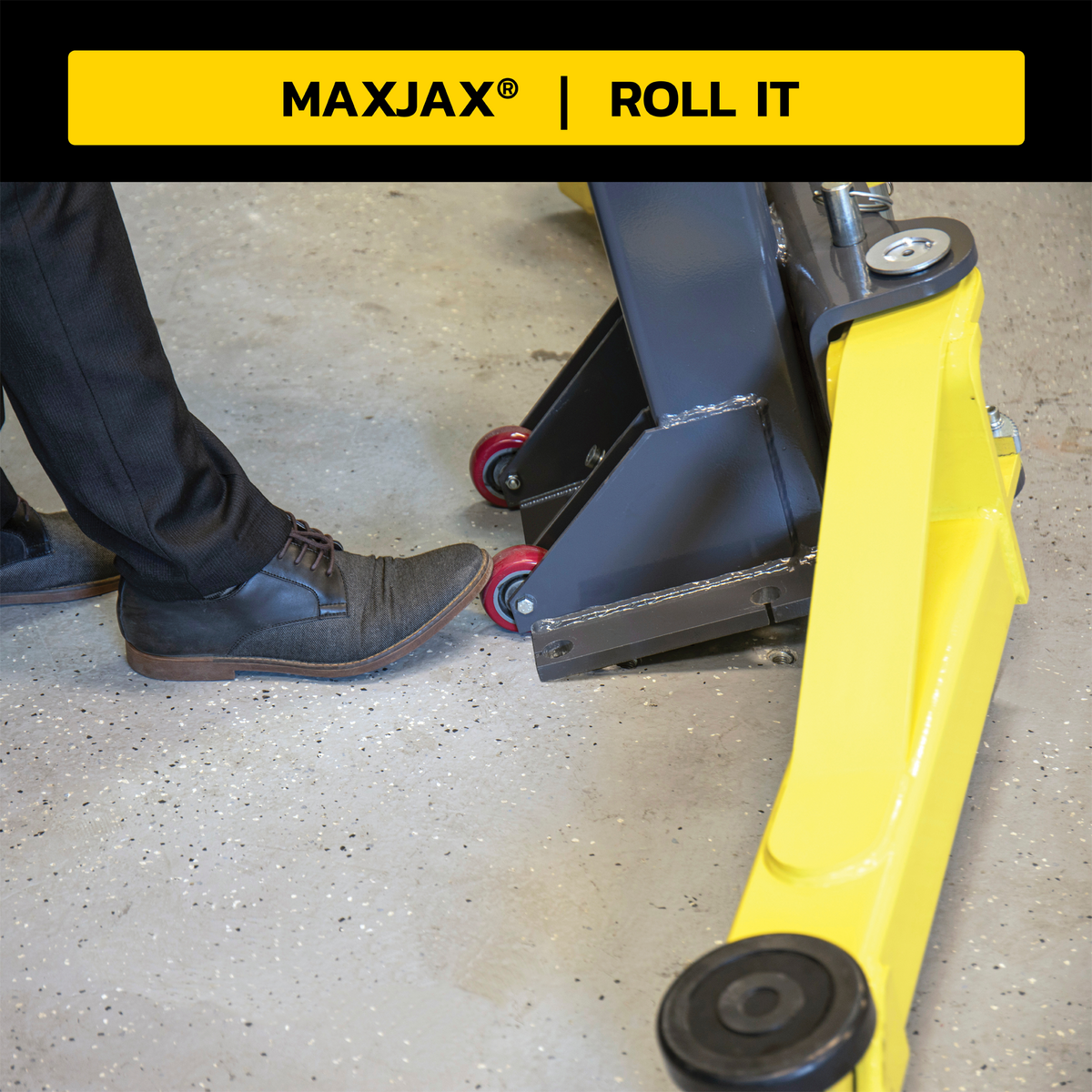 Close-up of MaxJax portable car lift showing rolling feature with heavy-duty wheels, as a person steps on the pedal to maneuver the lift.