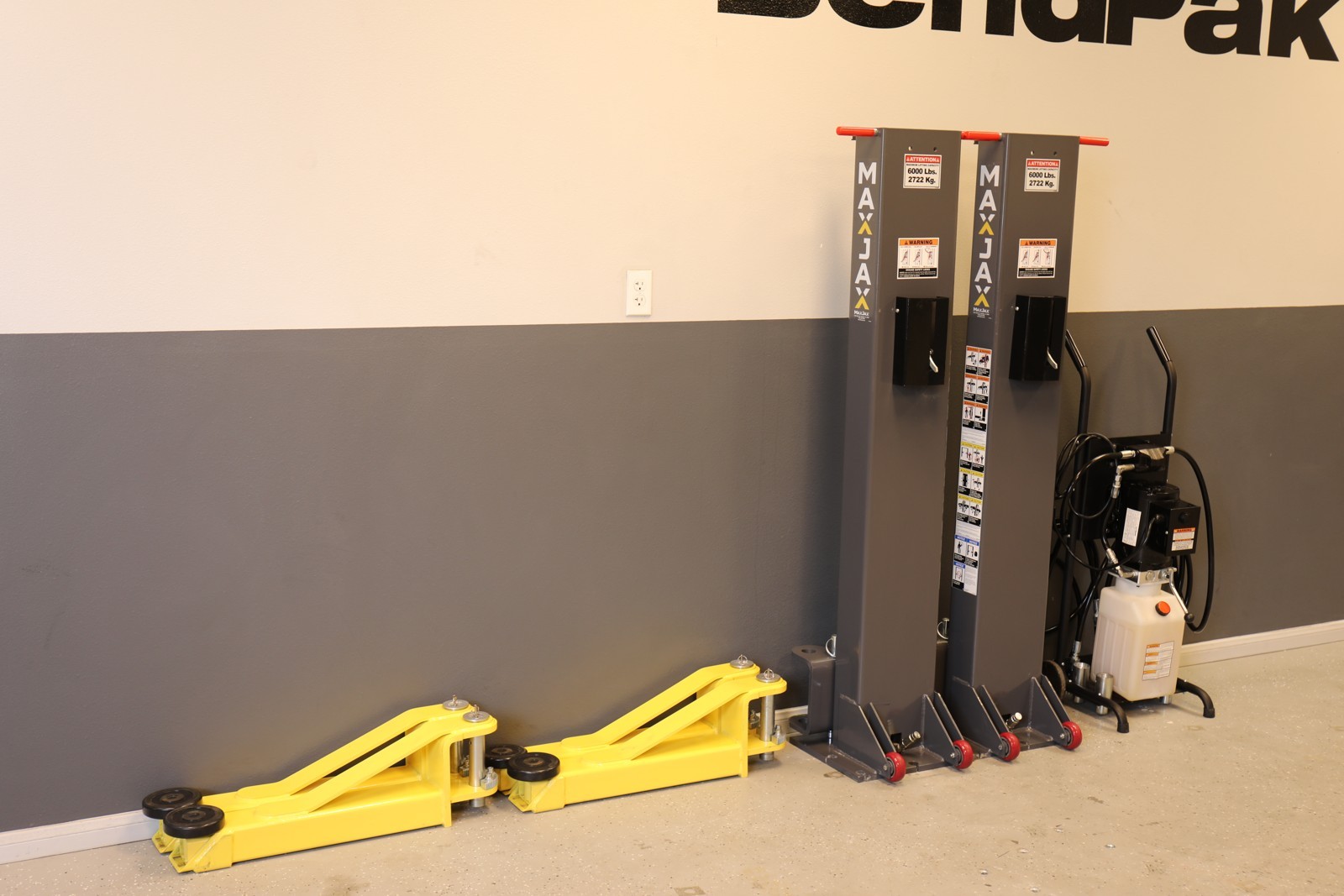 MaxJax’s portable two-post lift features flush-mounted anchors for easy setup, storage, and garage space-saving.